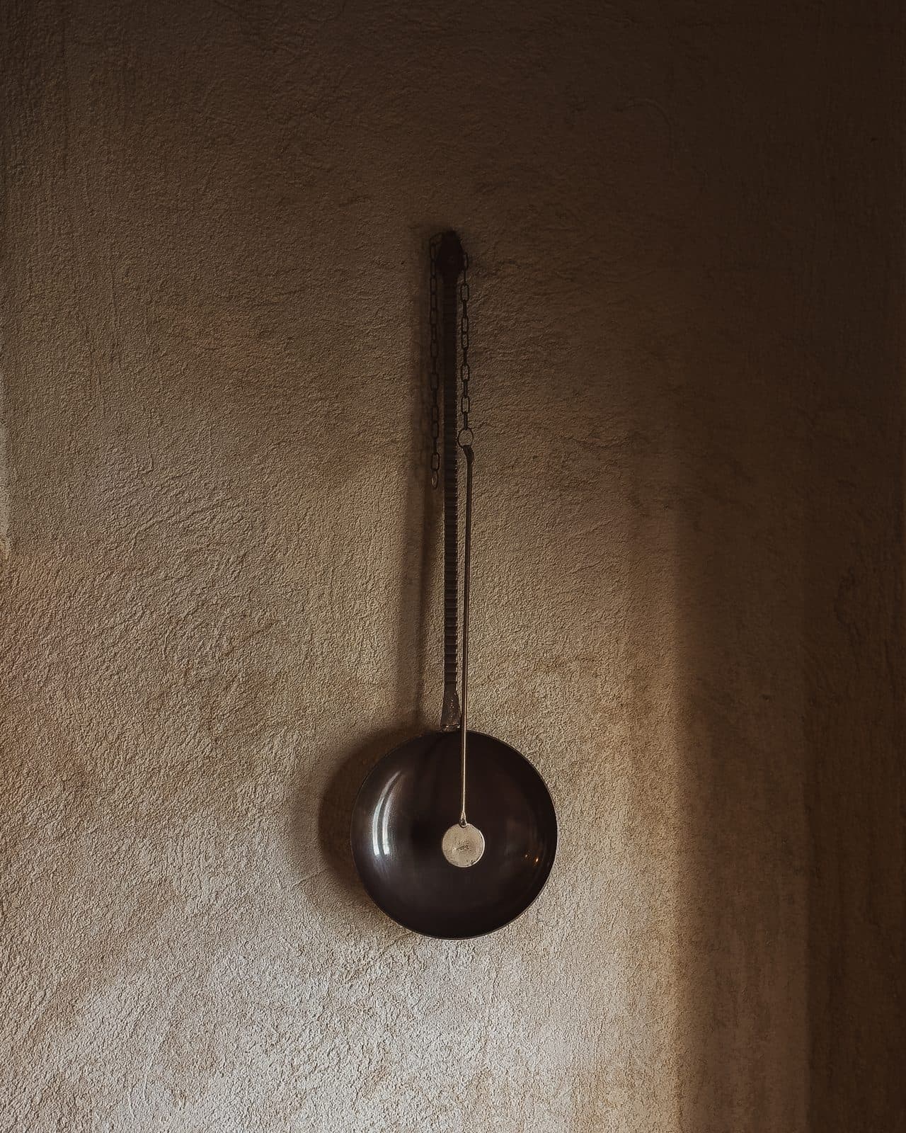 A traditional piece hung on the restored plaster wall