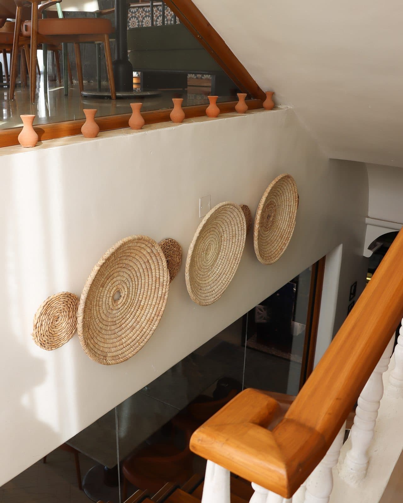 Woven palm trays arranged along the upper landing