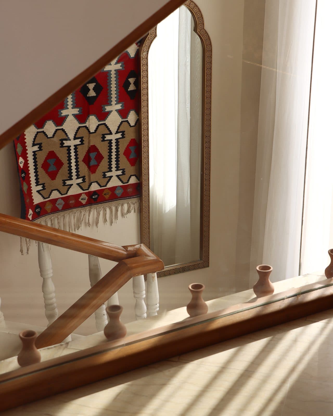 A kilim rug reflected in an antique carved mirror