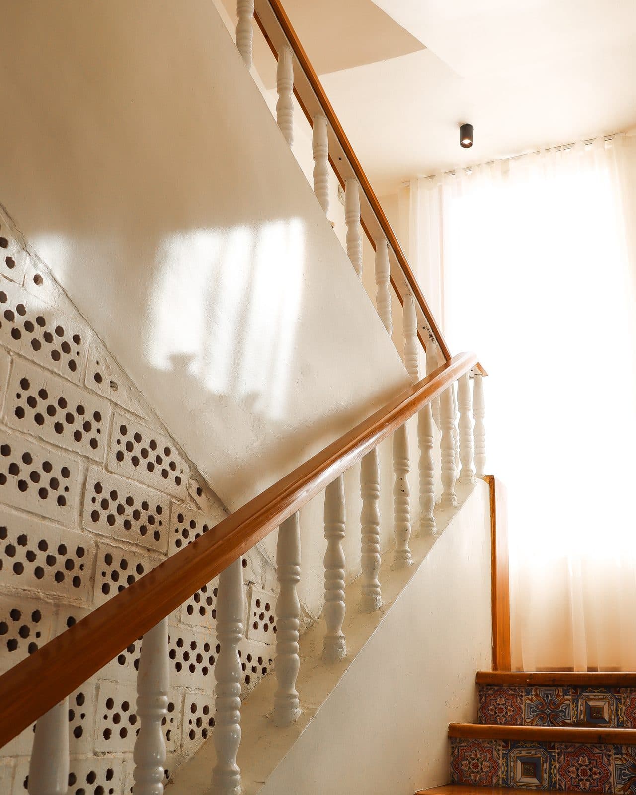 Sunlight on the carved white balustrade of the staircase